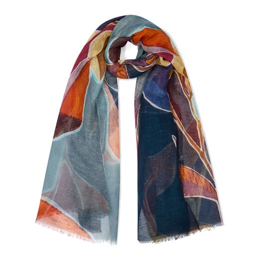 A looped scarf featuring a blue and ochre floral pattern.