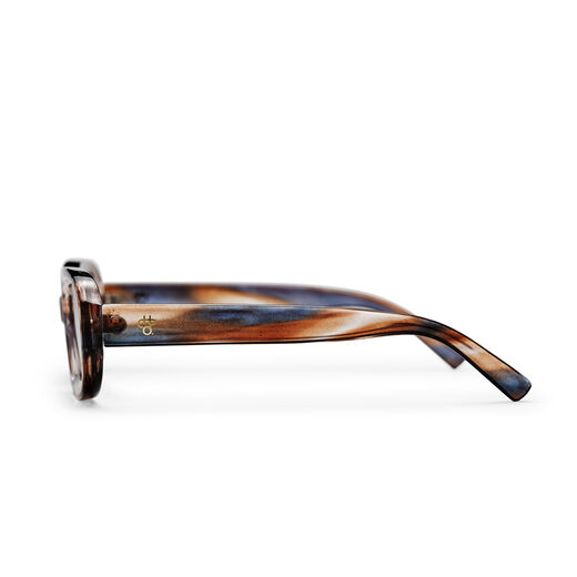 The side of a pair of sunglasses with a marbled brown and grey frame